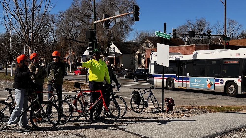 Cyclists viewing the Major Taylor Trail intersection at 105th and Vincennes